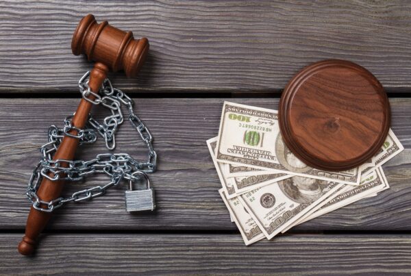 Legal Funding Contracts: Potential Red Flags blog image. Photo of a chained gavel next to some money.
