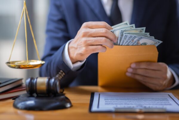 Legal Funding, Taxes, & Accounting blog image. Photo of a lawyer with an envelope & money.