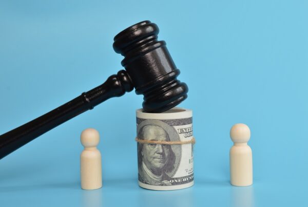 Does a Lawyer Need to Be Involved in Legal Funding Agreements? blog image. Photo of a gavel resting on top of a roll of $100 bills.