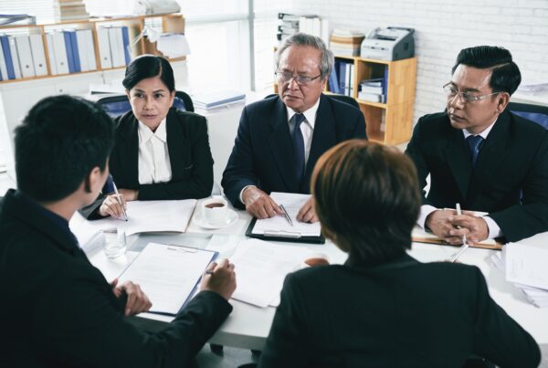 What Happens If You Lose Your Case After Getting Legal Funding. Image of a group of lawyers in discussion.