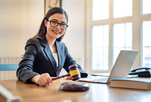 How Insurance Companies Use Delay Tactics and How Legal Funding Helps. Image of a woman working in a legal office.