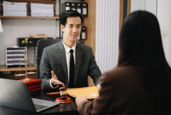 What Types of Medical Expenses Can You Cover With Pre-Settlement Funding? Photo of a man and a woman in a legal funding office.